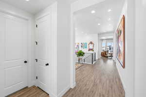 Corridor with recessed lighting and light wood-type flooring