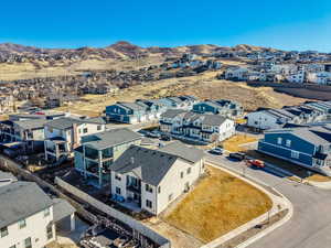 Aerial view of residential area featuring a mountainous background