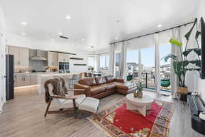 Living area featuring light wood-style floors and recessed lighting