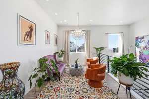 Sitting room featuring wood finished floors and hanging lights