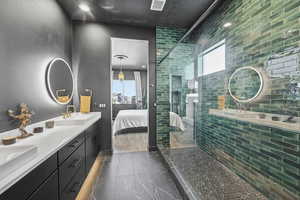 Bathroom featuring double vanity, ensuite bath, a shower stall, plenty of natural light, and recessed lighting
