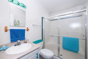 Full bath featuring vanity, a stall shower, and ornamental molding