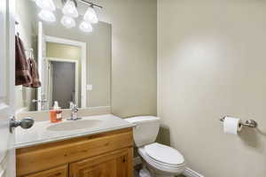 Half bathroom with toilet and vanity