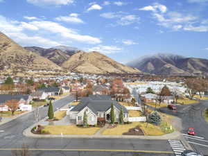 View of mountain backdrop featuring nearby suburban area