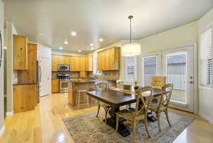 Dining room featuring light hardwood flooring and recessed lighting