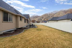 Fenced backyard featuring a patio area and a mountain view