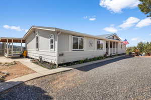 View of front of property featuring a metal roof and covered porch