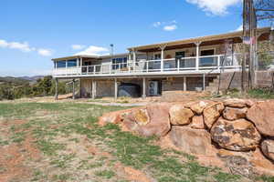 Rear view of property featuring a deck