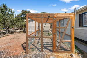 Wooden terrace featuring an outdoor structure and exterior structure