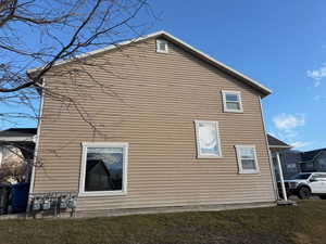 View of side of home with a lawn
