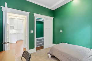 Bedroom featuring ornamental molding and a closet
