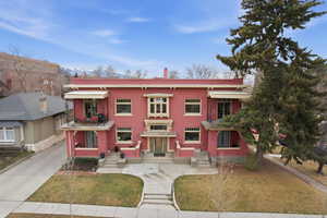 View of front of house with a front yard and a chimney
