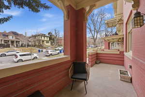 Covered porch featuring a residential view