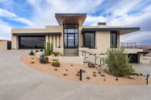 Contemporary house featuring stucco siding, concrete driveway, and a garage