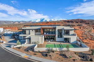 Contemporary home with a mountain view, a balcony, and stucco siding