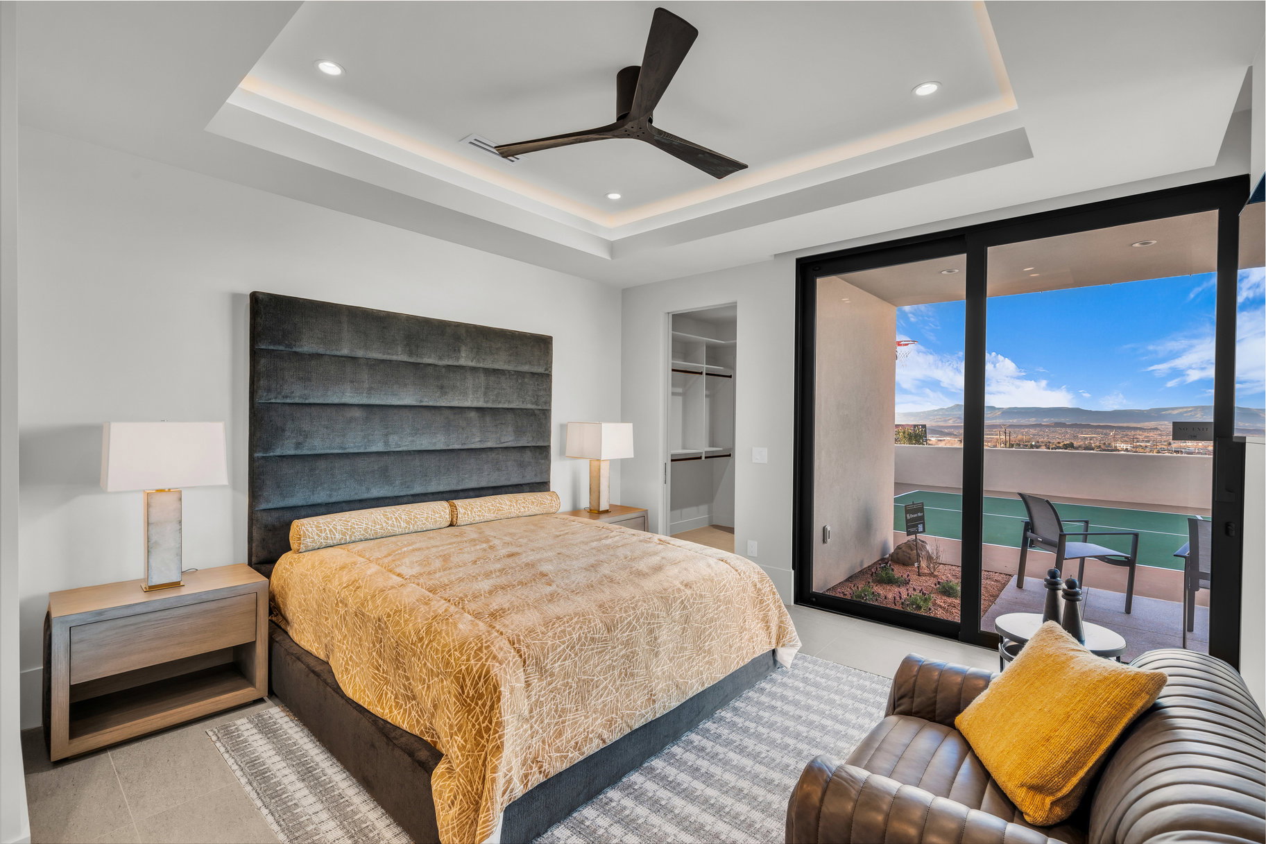 Bedroom with floor to ceiling windows, a walk in closet, a ceiling fan, access to exterior, and recessed lighting