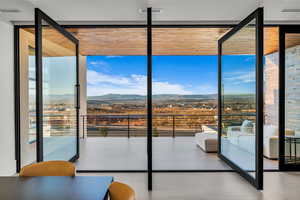 Entryway with floor to ceiling windows and a mountain view