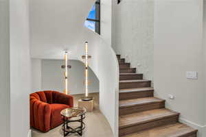 Staircase featuring a high ceiling