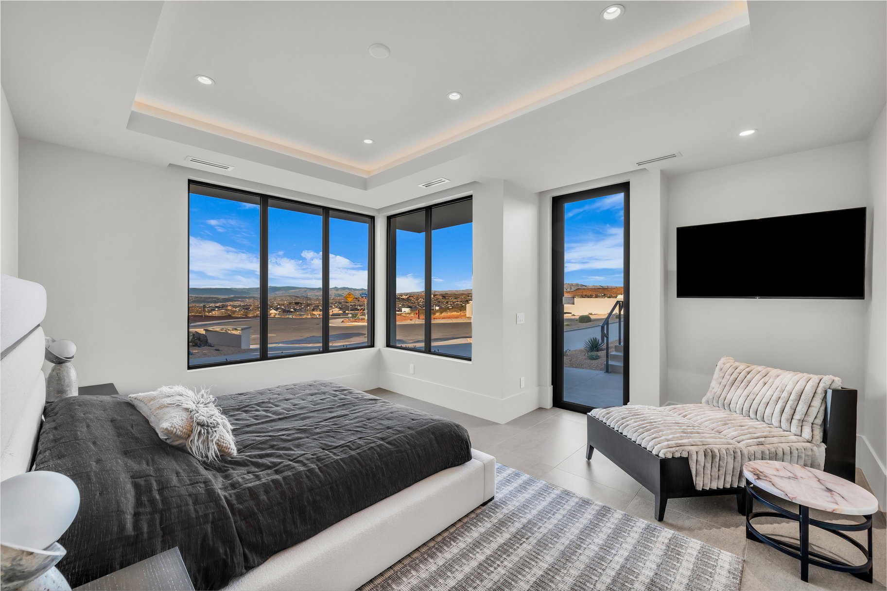 Bedroom featuring access to outside, recessed lighting, and a tray ceiling