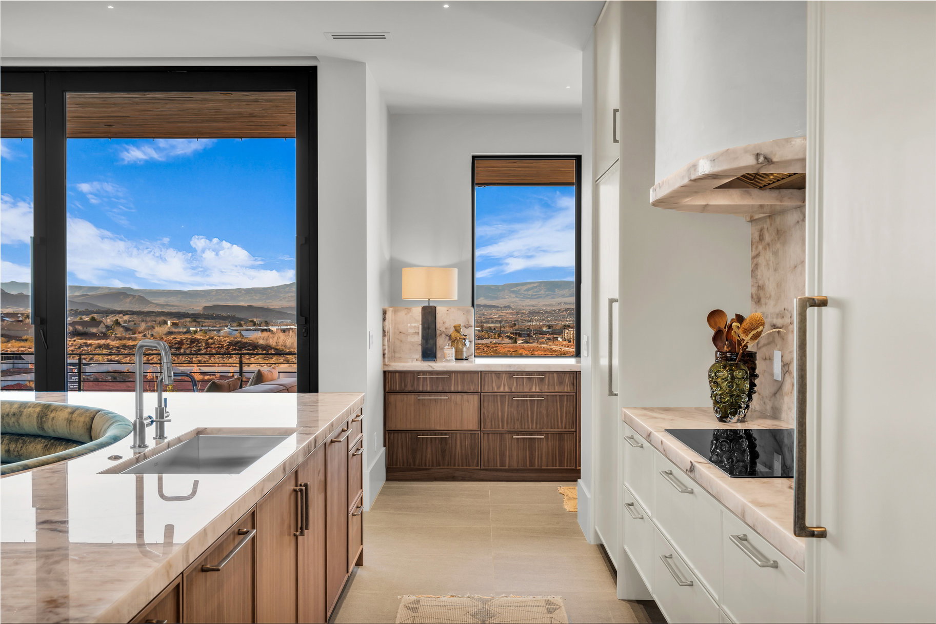 Dual tone kitchen with a mountain view, freestanding refrigerator, black electric stovetop, modern cabinets, and dual tone cabinetry