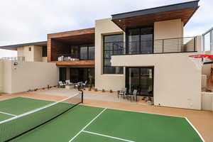 View of sport court with a patio area