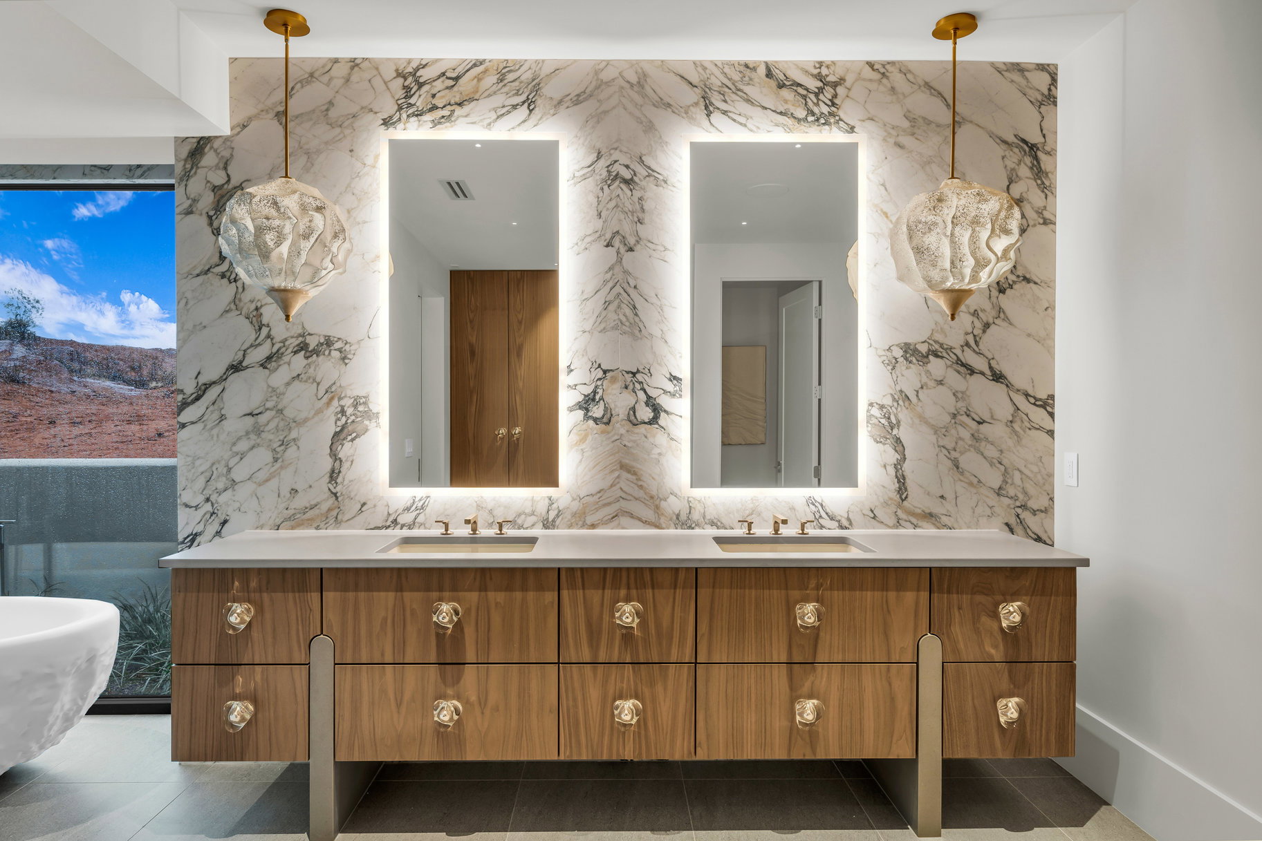 Bathroom with double vanity and stone wall