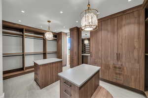 Walk in closet featuring a chandelier