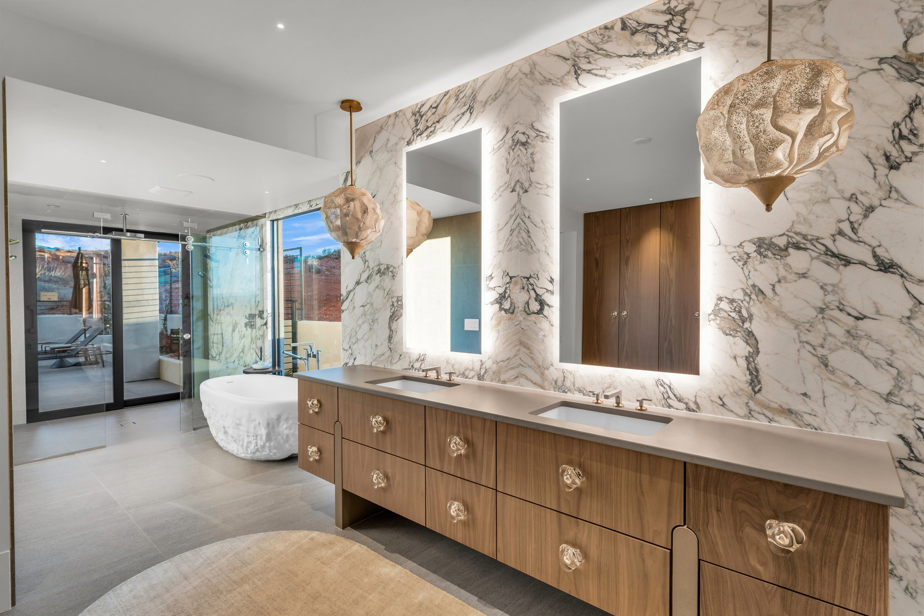 Bathroom with a soaking tub, double vanity, and tile walls