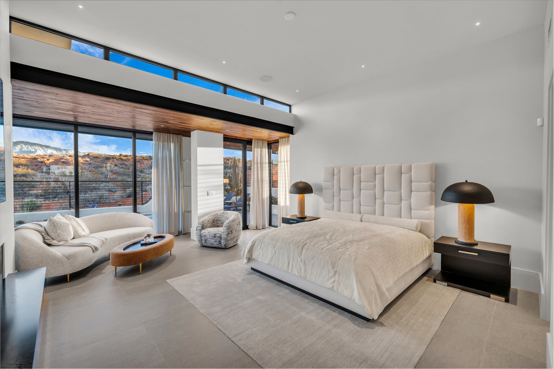 Bedroom with expansive windows and access to outside