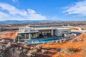 Rear view of property featuring a mountain view, a patio area, and stucco siding