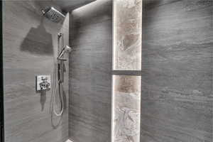 Bathroom featuring a tile shower