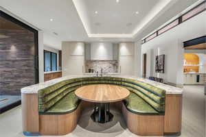 Bar with modern cabinets, light stone counters, recessed lighting, and a tray ceiling