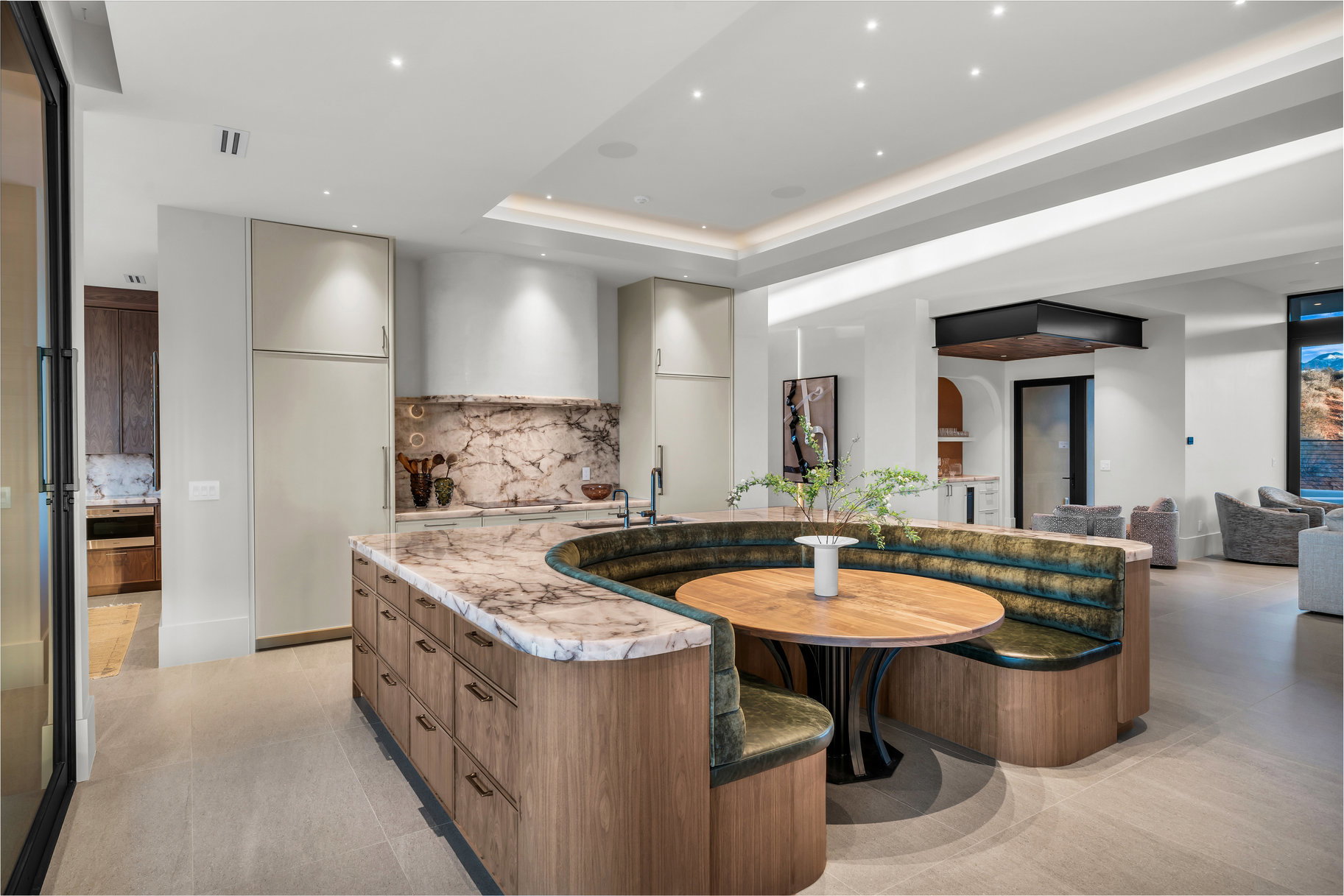 Kitchen featuring modern cabinets, light stone countertops, tasteful backsplash, recessed lighting, and open floor plan