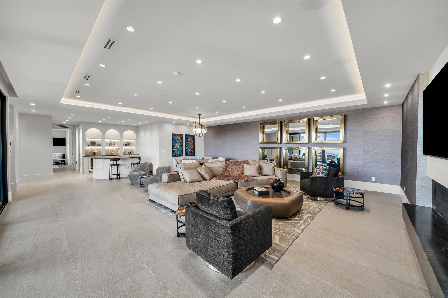 Living room featuring a tray ceiling and recessed lighting