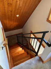 Staircase featuring wooden ceiling and recessed lighting