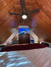 Bedroom with a ceiling fan and wooden ceiling