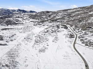 Snowy aerial view featuring a mountain view