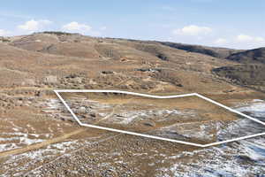 Aerial overview of property's location with rural landscape and mountains