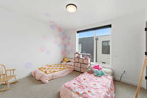 Bedroom featuring carpet flooring and baseboards