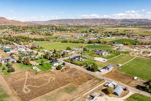 Aerial view of property's location featuring a mountainous background and nearby suburban area
