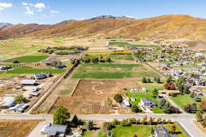 Overview of rural landscape with a mountainous background and large plots for crops