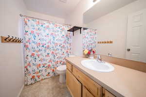 Bathroom with vanity and curtained shower