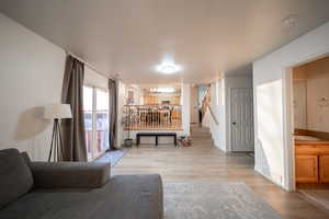 Living area with light wood finished floors and stairs