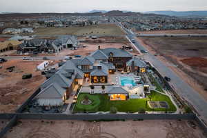 Aerial view of residential area featuring a mountainous background and a pool area