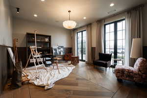Office area featuring hardwood / wood-style flooring, recessed lighting, and a wainscoted wall
