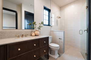 Full bath with a shower stall and vanity