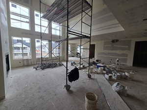 Miscellaneous room with a high ceiling and a fireplace