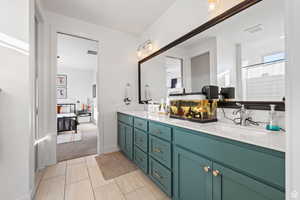 Full bath featuring double vanity, a shower with shower curtain, and light colored carpet