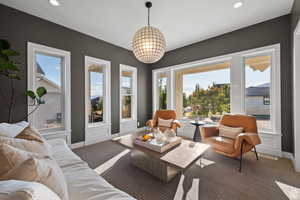 Carpeted living area featuring healthy amount of natural light and recessed lighting