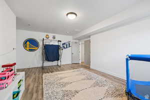 Recreation room with wood finished floors and baseboards